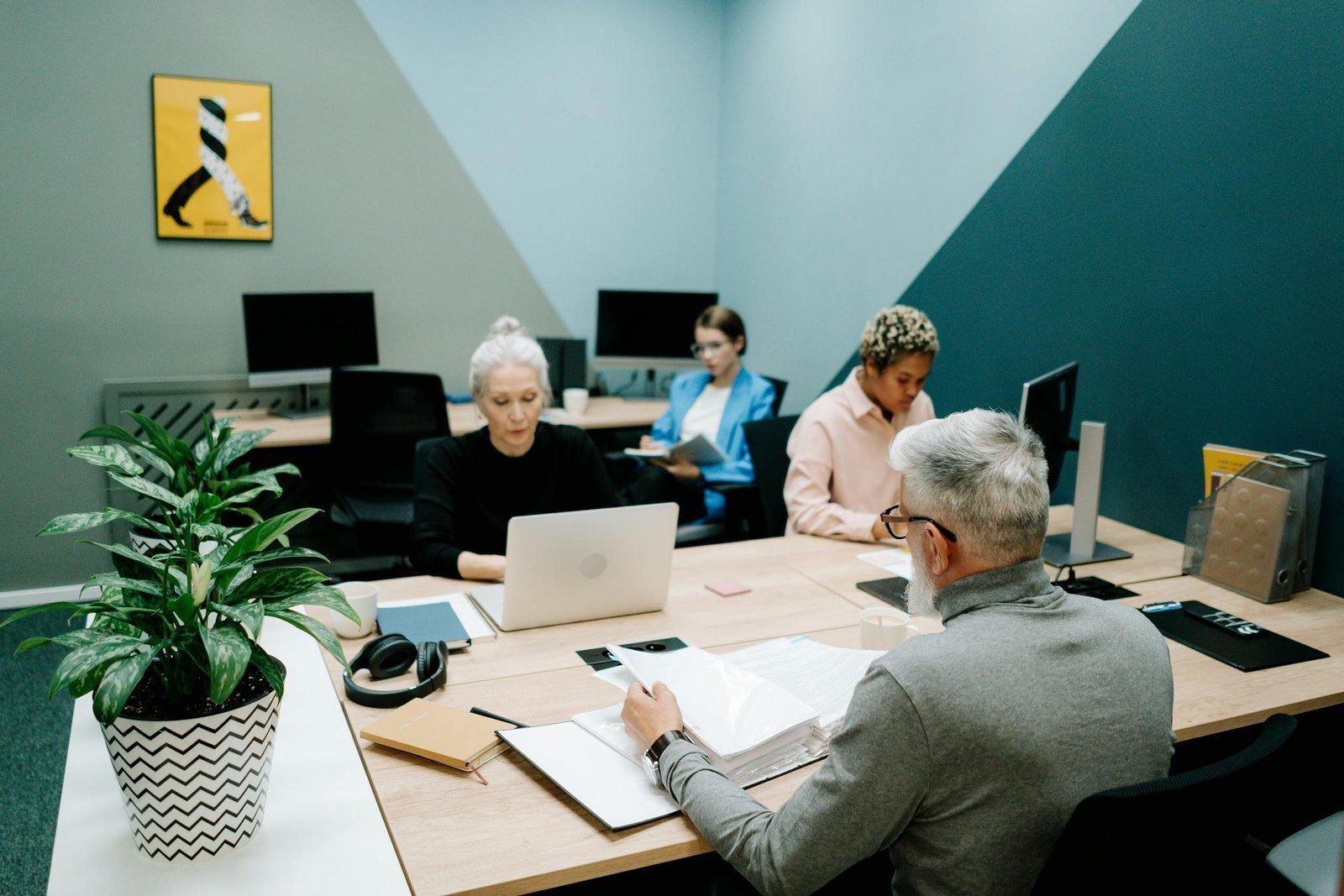 Reducing the Angst 1 A diverse group of professionals working together in a modern office environment, focusing on teamwork and collaboration.
