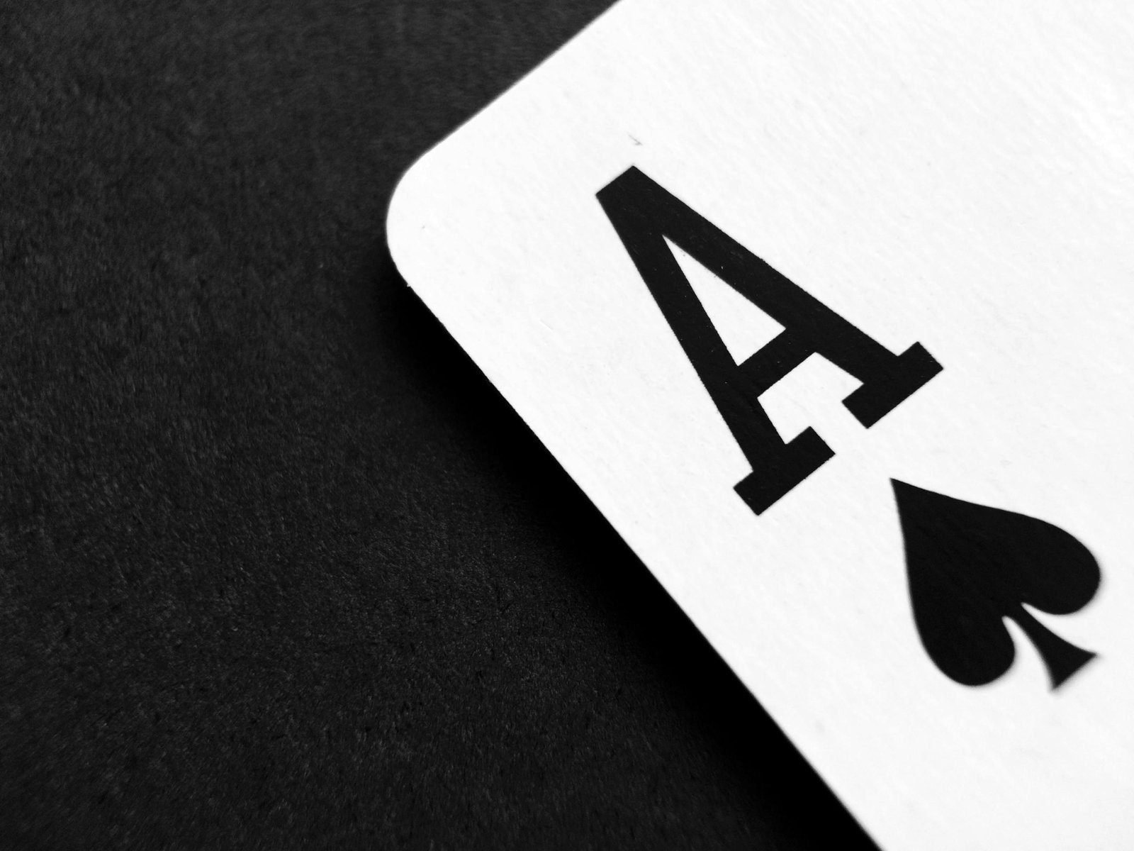Negotiating Lessons from the Game of Bridge 1 Detailed view of an Ace of Spades card symbolizing luck and strategy.