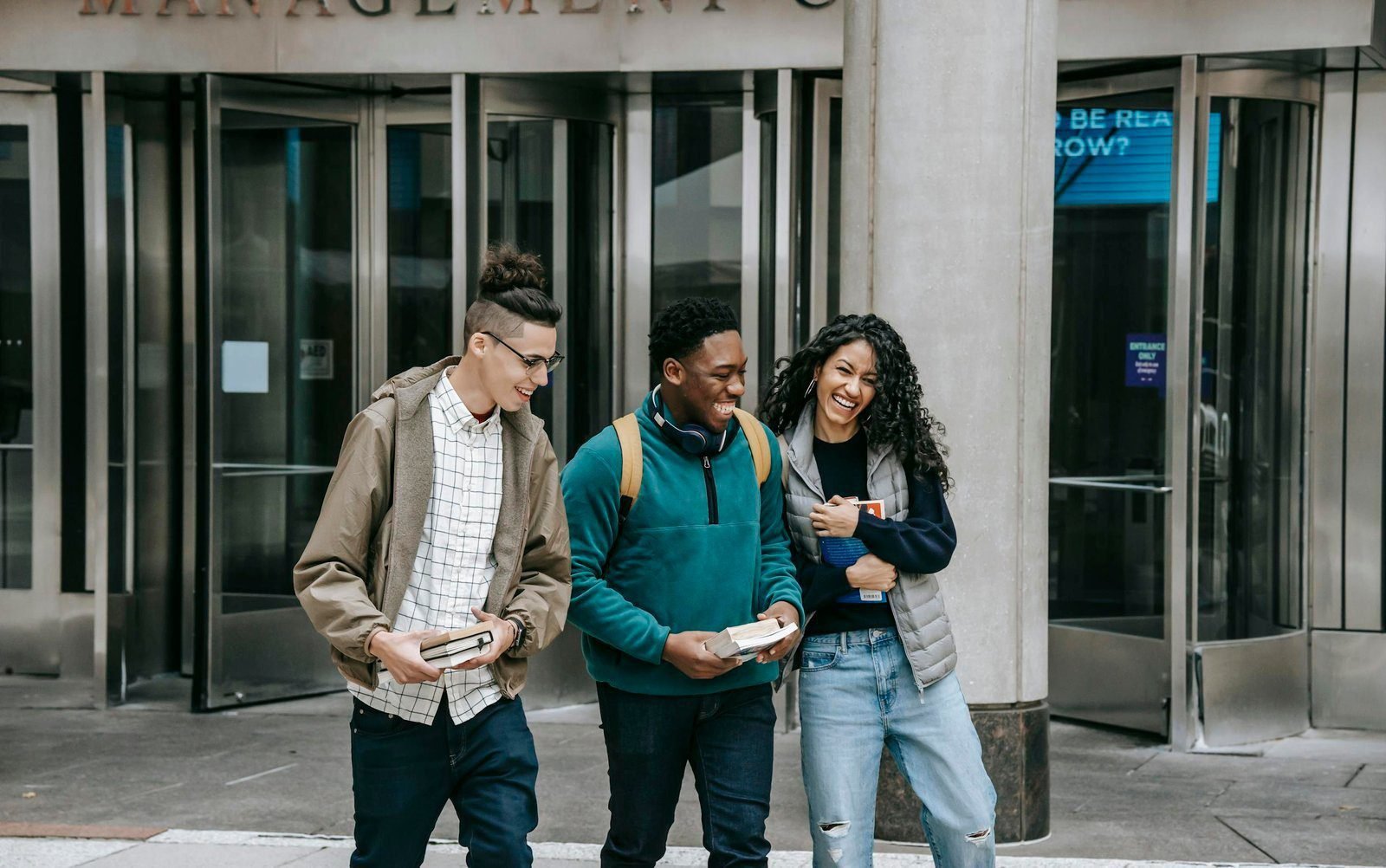 Don’t Manage People, Manage Culture 1 Young cheerful multiethnic students with books having fun on urban pavement while speaking in daylight